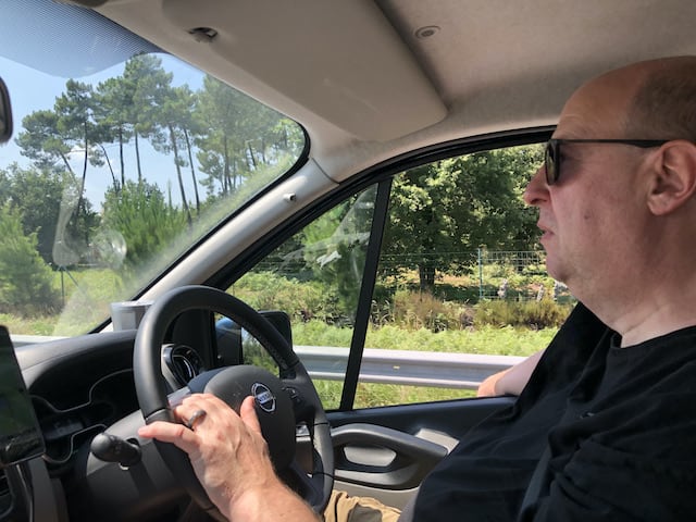 Man in sunglasses and black t shirt driving