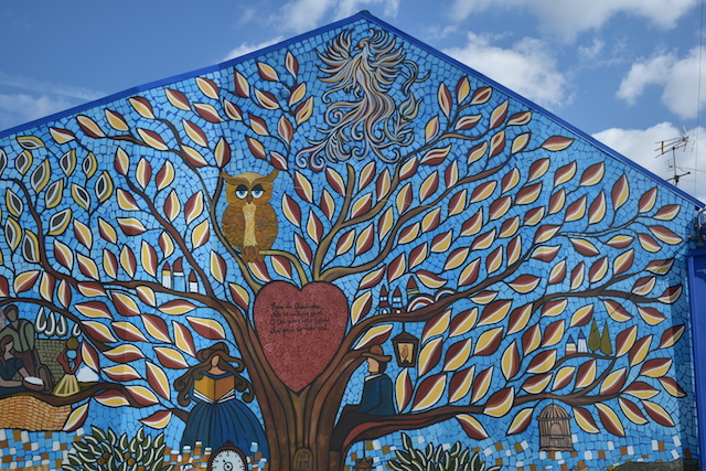 mural with tree and heart on side of building