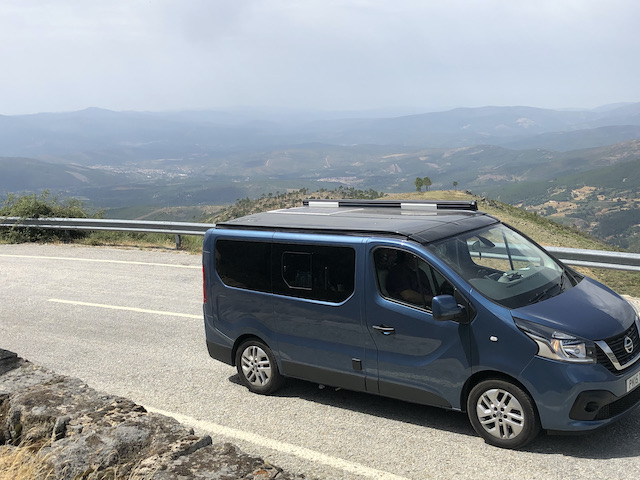 campervan on road high in mountains