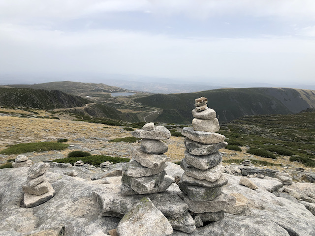 tower of stones on top of mountain summit