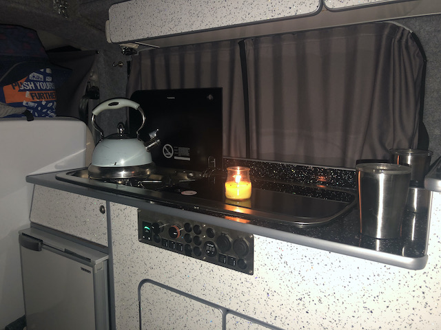 kitchen with blue kettle in campervan