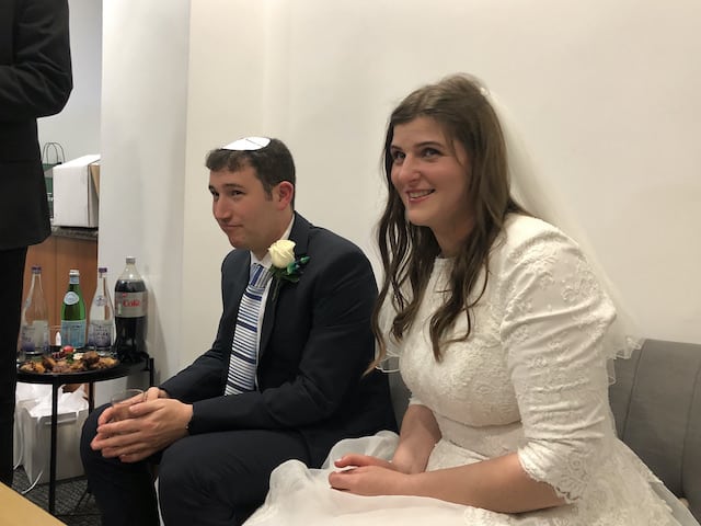 bride and groom sitting down